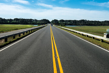 asphalt road with yellow markings.