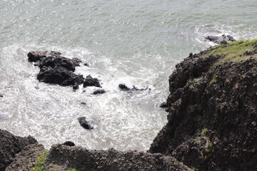 Rocky shore murky due to rough waves