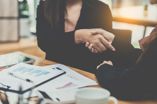 Business partnership meeting concept. Image business woman handshake. Successful business people handshaking after good deal. Group support concept.