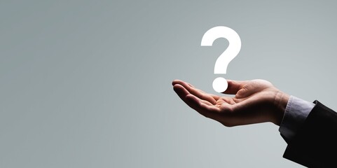 businessman hand holding question mark. concept of Question mark and FAQs, Ask quiestion online