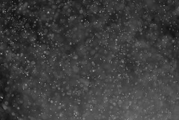 Dark grey glitter bokeh gradient background.
