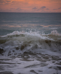 Ocean waves rolling in towards the wet sandy shore at Ocean beach