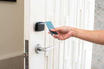 women hand open the Door with keycard