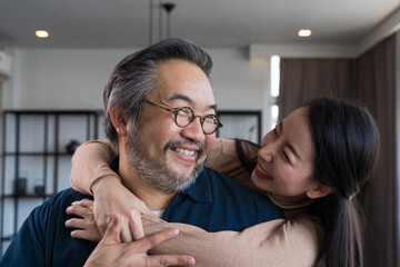 Middle-aged Asian couple smiling for the camera. Family couple portrait