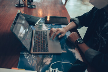 Travelers planning trips and use laptop to book hotels, buy plane tickets, search map, or find travel routes. Travel concept.