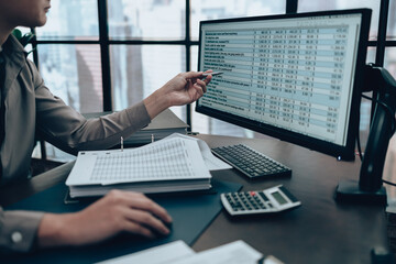 Investors working on desk office and use computer  to check data cost, balance, profit and ...