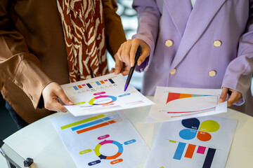 Businesswoman and partner hands holding pointing graph chart, Finance and Accounting for Plans to...
