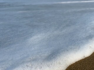 Smooth sea foam on the sea shore
