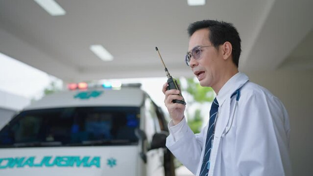 Paramedic using a radio to report an emergency