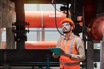 Engineer under checking the industry cooling tower air conditioner is water cooling tower air chiller HVAC of large industrial building to control air system.