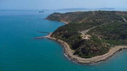 Drone photos of El Morro hill, recorded in the middle of a sunny morning, in the videos you can see, El Morro hill, hills, mountains, coasts, roads, trees on the shore of the beach, beach, rocks, sand