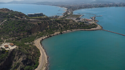 Drone photos of El Morro hill, recorded in the middle of a sunny morning, in the videos you can see, El Morro hill, hills, mountains, coasts, roads, trees on the shore of the beach, beach, rocks, sand