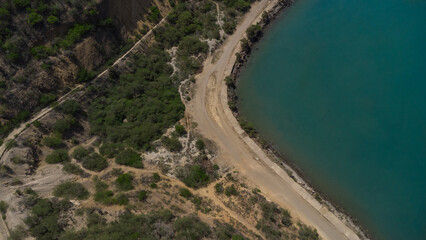 Obraz premium Drone photos of El Morro hill, recorded in the middle of a sunny morning, in the videos you can see, El Morro hill, hills, mountains, coasts, roads, trees on the shore of the beach, beach, rocks, sand