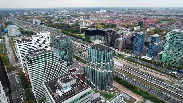 Bird's aerial view of Amsterdam Zuid Business banking district, pan, day