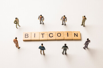 businessman figures at bitcoin words