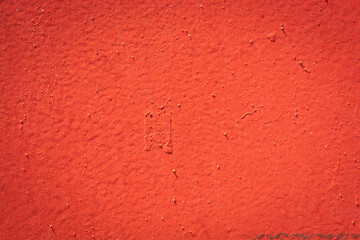 red metal plate with cracked paint and big paint spots because of time as background, metal wall with rusty spots and cracked paint as texture, toned to color, high quality resolution