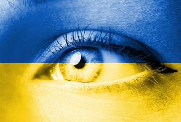 A Children's eyes full of sadness in Ukraine flag colors