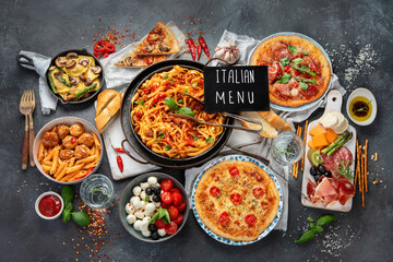Italian food assortment on dark background.