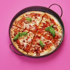 Pizza on pink background.