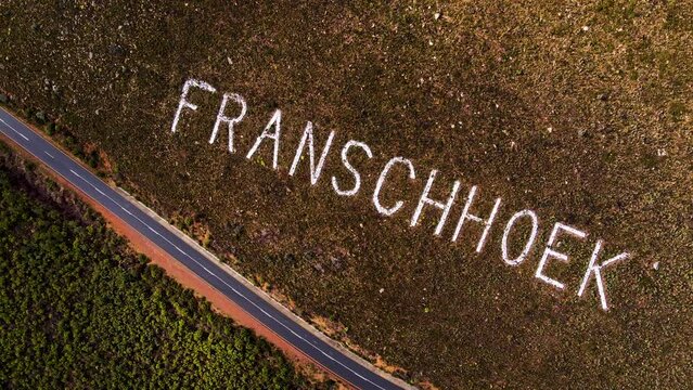 Aerial descent over Franschhoek place name on mountainside of pass