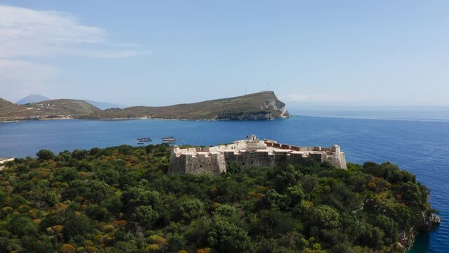 Aerial of Ali pasha fortress Venetian Triangular Castle Porto Palermo located on beautiful island along vast blue sea.