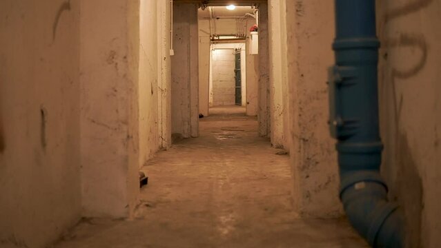 A View Of Dirty Walls And Empty Walkway At the Old Basement. Tilt-up Shot