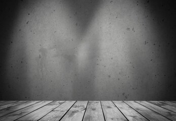 Empty wooden floor and blank grey concrete wall in spotlit lights interior studio room.