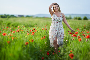 Beautiful plus size woman in a poppy field