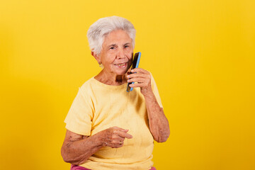 Old lady, holding cell phone, inclusion of the elderly in the digital environment, online,...