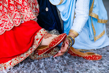 Indian Punjabi bride's red wedding shoes close up
