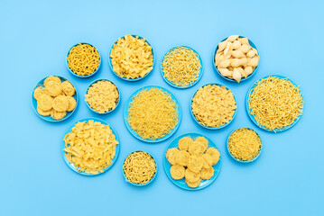 Pasta variety in blue plates above view on a blue table.