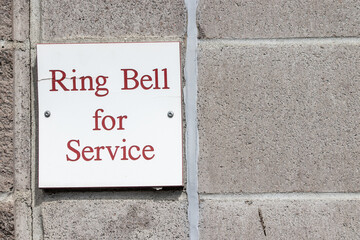 Obraz premium Ring bell for service sign on a wall