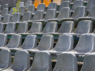 seats of tribune on sport stadium. empty outdoor arena. concept of fans. chairs for audience. cultural environment concept. symmetry. empty seats.