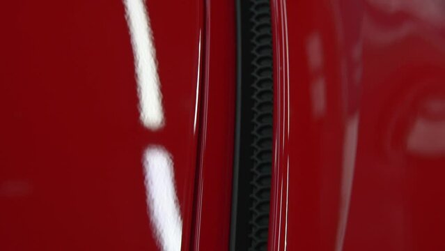 Red, luxury, sport, muscle car air intake detail. Racing automobile shiny hull side pan.