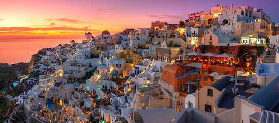 Oia town on Santorini island, Greece. Traditional and famous houses and churches with blue domes over the Caldera, Aegean sea