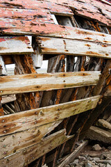 Stranded wood fishing boat rotting away on a tidal flat