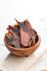 Beef jerky meat. Dried sliced meat in wooden bowl.