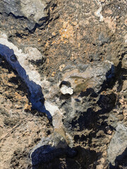 Coast of the Mediterranean Sea, long frozen lava. Background. It looks like an alien landscape.