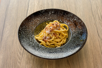 pasta carbonara on a dark dish