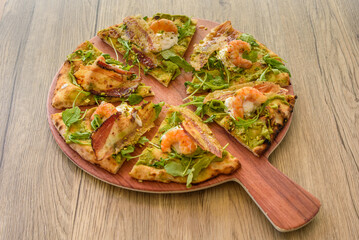 Pizza with bacon and shrimp on a table