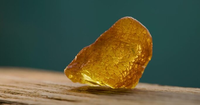 Natural amber Stone spinning in green background