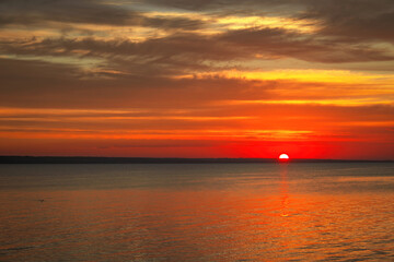 Dramatic sunset sky with clouds. Breathtaking sunset over the sea