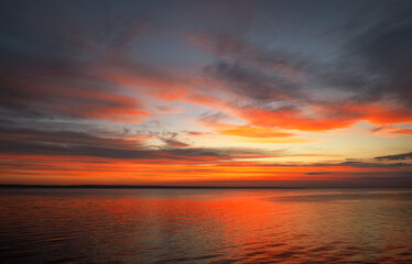 Dramatic sunset sky with clouds. Breathtaking sunset over the sea