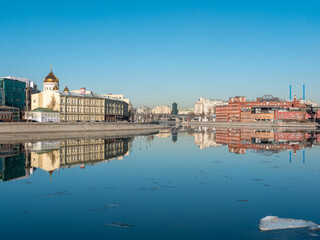 Fototapeta premium Moscow, Russia - March 01, 2022: Beautiful view of the embankment of the Muzeon Park, the Cathedral of Christ the Savior and the Red October factory building against the blue sky. Copy space