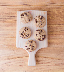Some cookies on the cutting board. Closeup picture of some chocolate cookies.	
