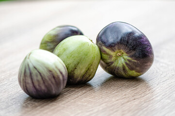 fresh and delicious tomatoes of green-black colored sort on a wooden table, closeup