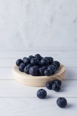 A few blueberries are on the counter in the kitchen