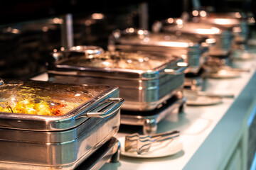 Catering buffet food with heated trays ready for service in hotel restaurant