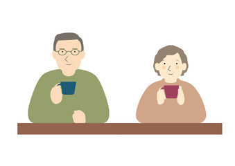マグカップを持ってテーブルについている中高年夫婦