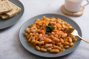 Stewed beans with vegetables in spicy tomato sauce on a plate